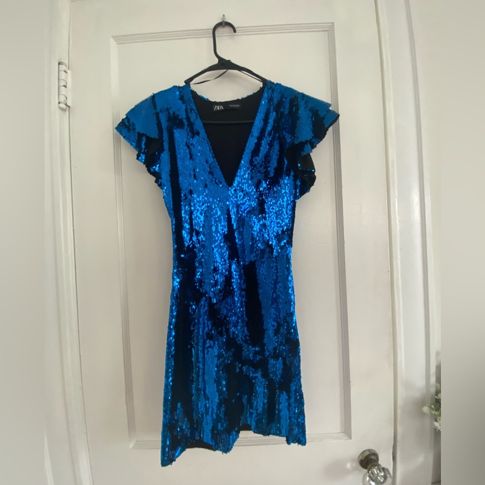 Blue sparkle bodycon dress with a V neck and frill sleeves